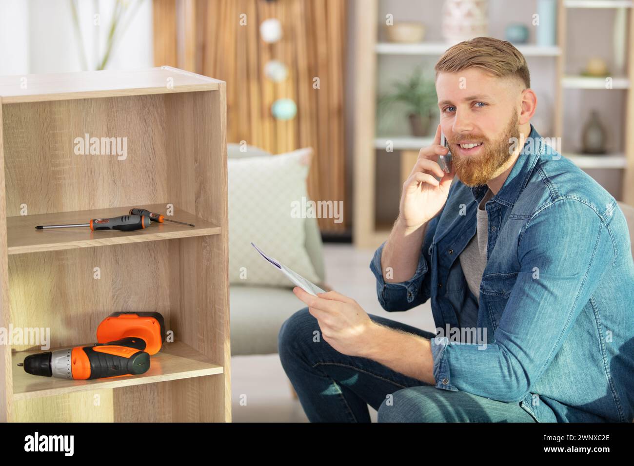 Happy man reading instructions hi-res stock photography and images - Alamy