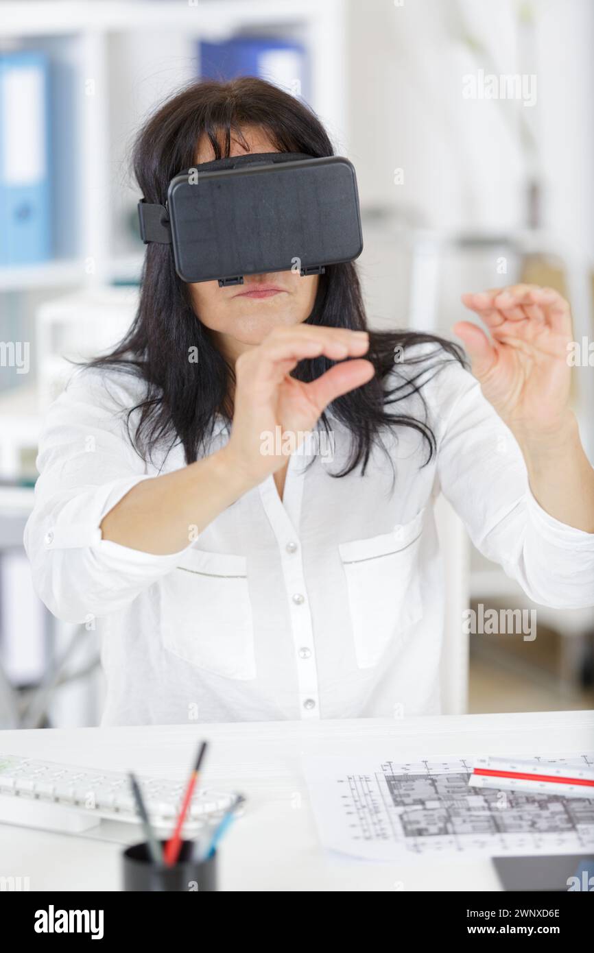 senior female executive using virtual reality headset Stock Photo