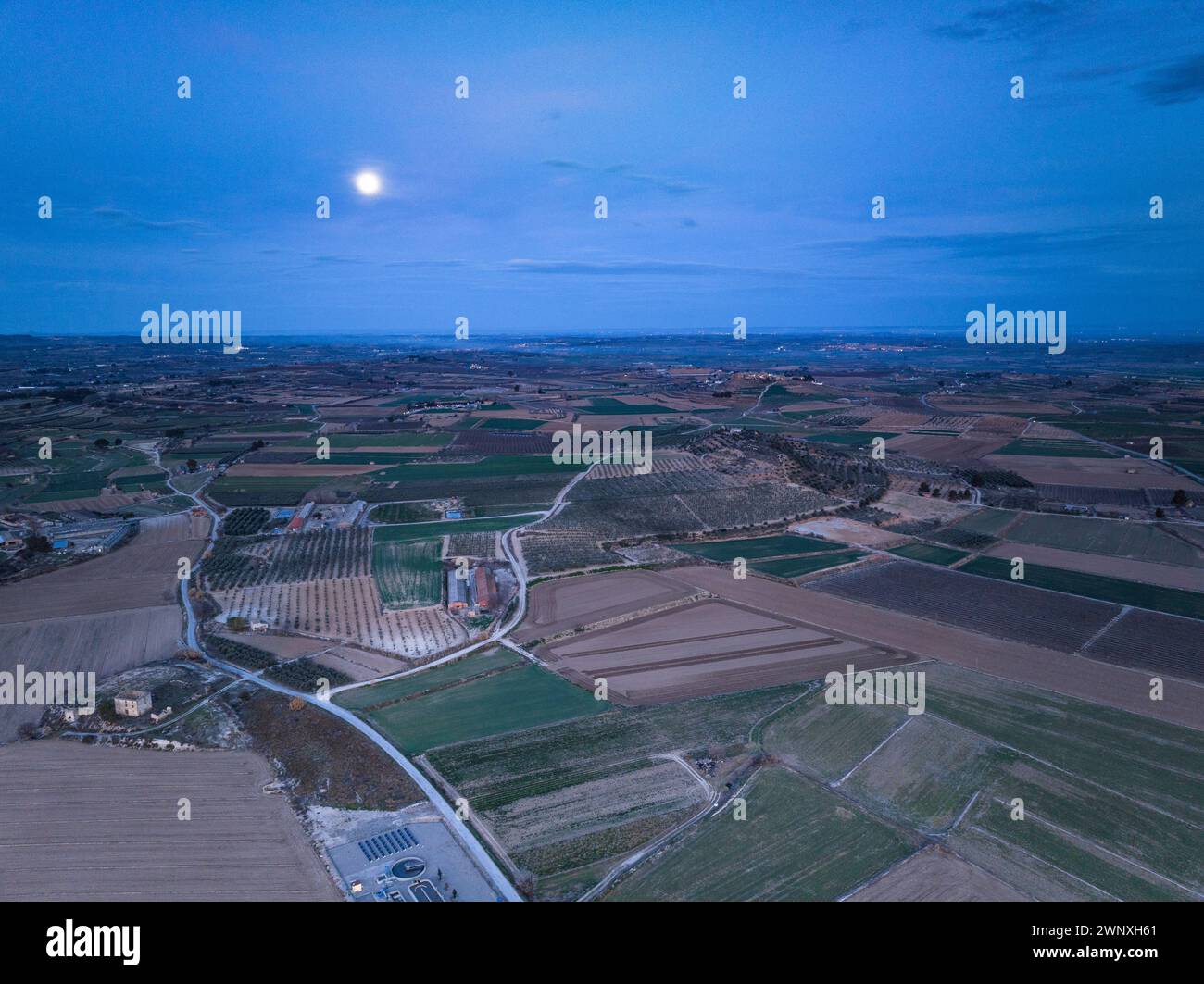 Aerial view of the town of Arbeca and its rural surroundings in a reddish sunrise (Les Garrigues, Lleida, Catalonia, Spain) Stock Photo