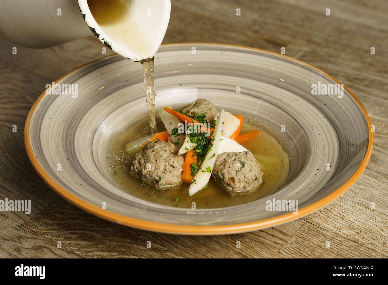 Goose soup, consommé with dumplings and vegetables Stock Photo
