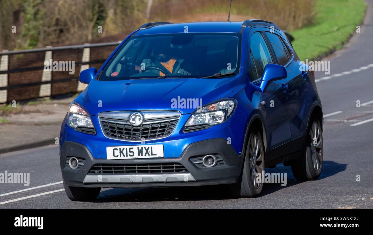 Milton Keynes,UK-Mar 4th 2024: 2015 blue Vauxhall Mokka car driving on an English road Stock Photo