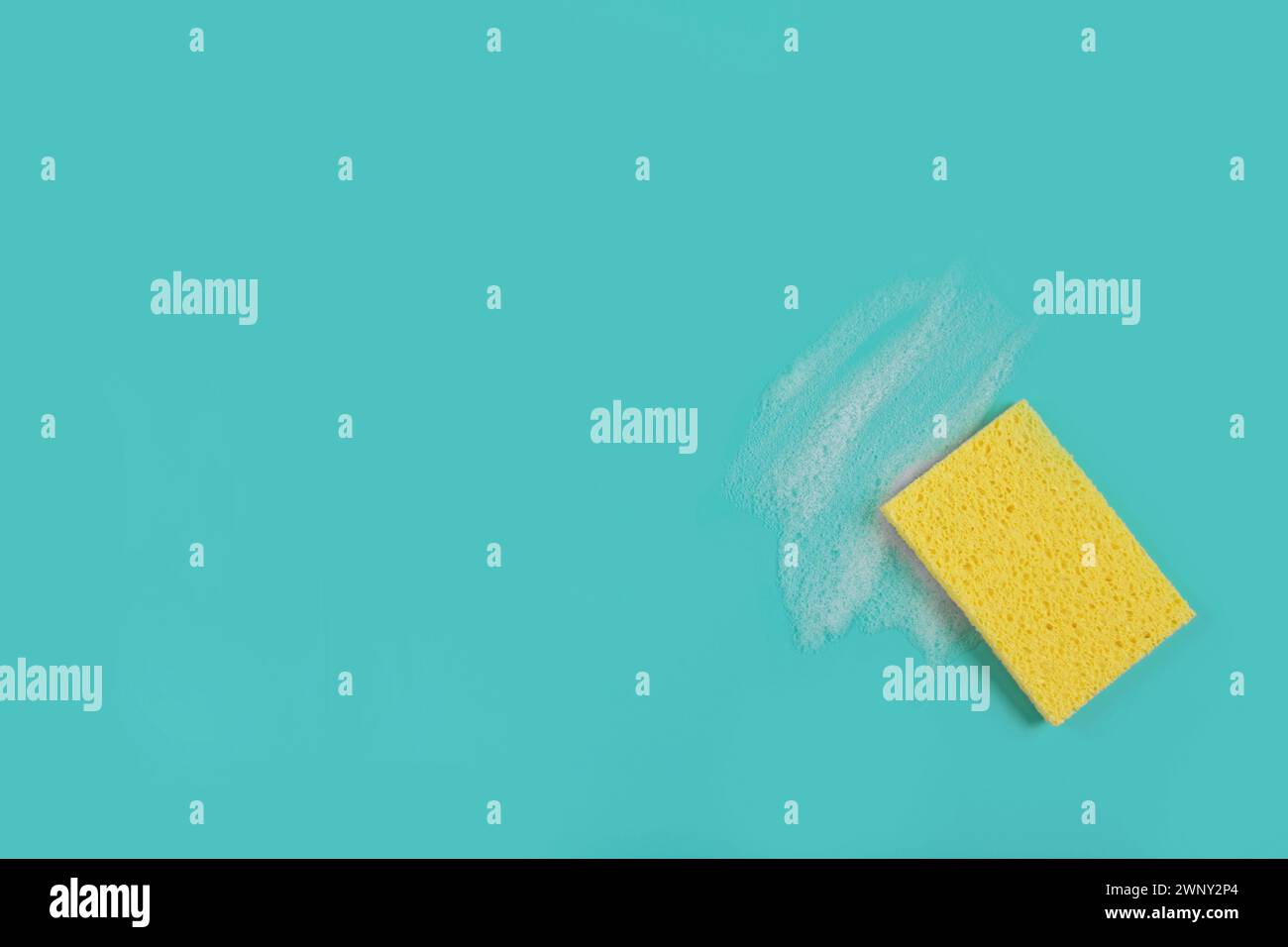 Washing Sponge lying on surface in soapy foam Stock Photo