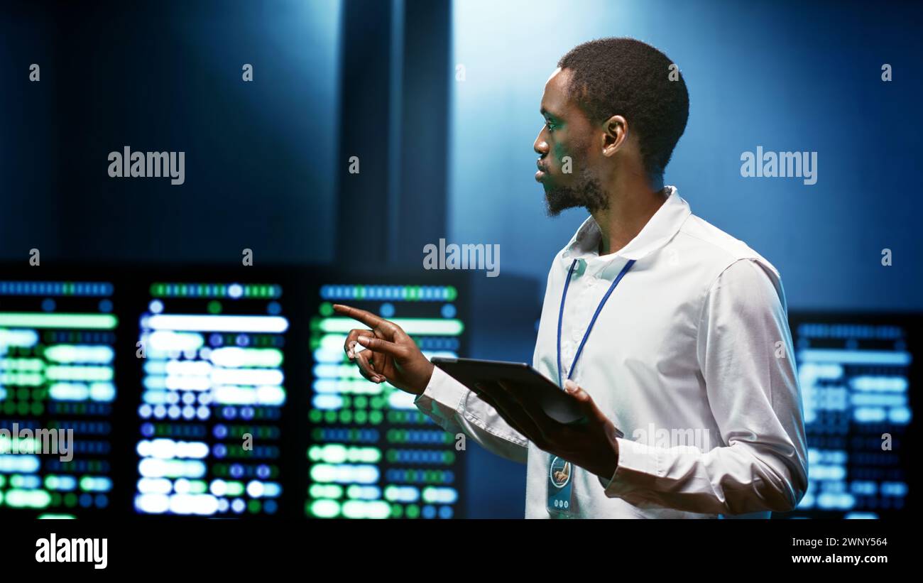 African american specialist using tablet to check data center security
