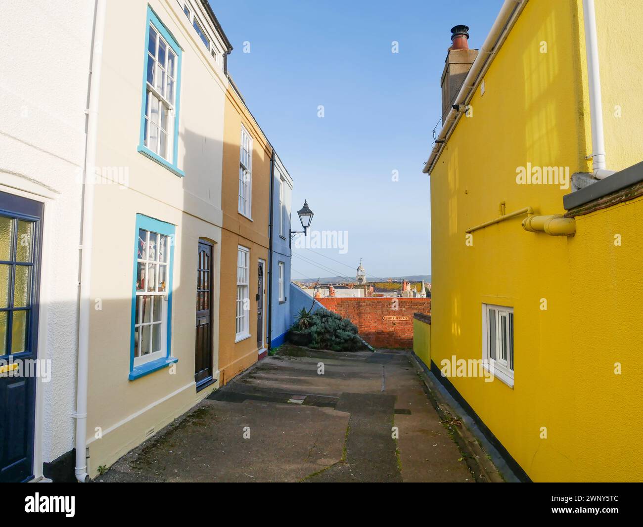 Terraced houses on Hartlebury Terrace off Franchise Street with Trinity Terrace in the distance in Weymouth, Dorset, England. Stock Photo