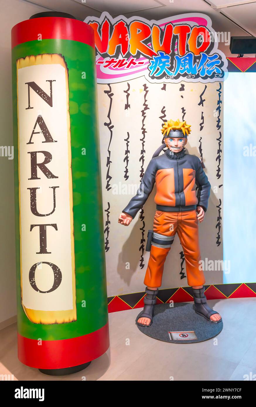 ikebukuro, japan - jan 16 2024: Life sized figurine featuring the manga hero of Naruto Shippuden aside a giant scroll at the entrance of the free exhi Stock Photo