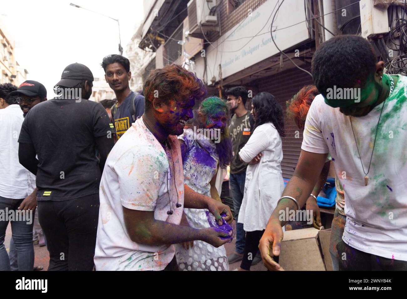 Chennai, Tamilnadu India - March 08 2023 : colorful street Holi celebration by large number of local people in Mint street, Holi festival portrait or Stock Photo