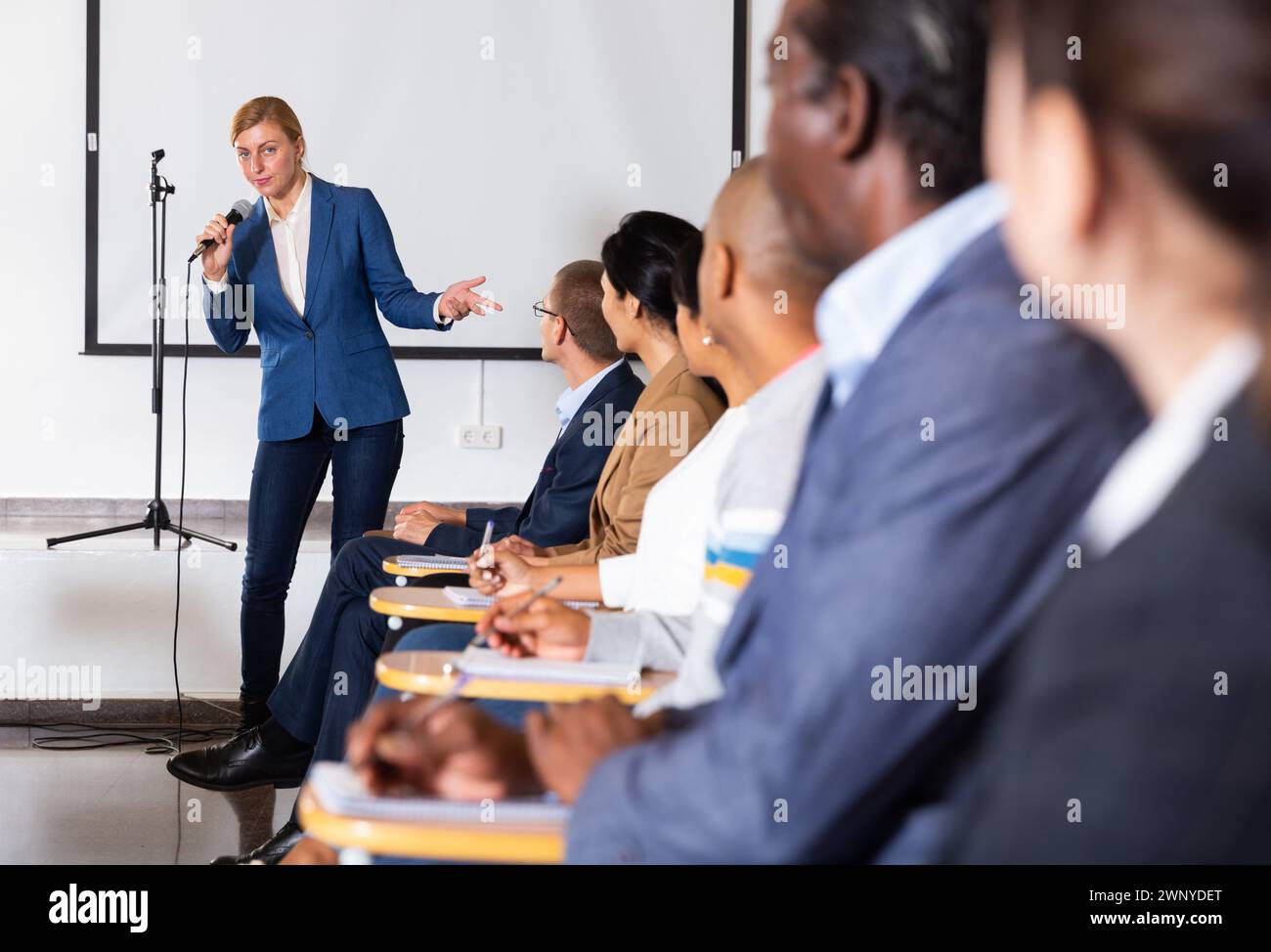 Woman with microphone, public speaking course. hi-res stock photography ...