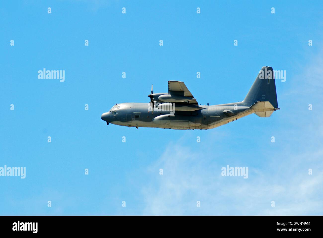 A propeller engine  Lockheed -130 Hercules airplane flies across the sky Stock Photo