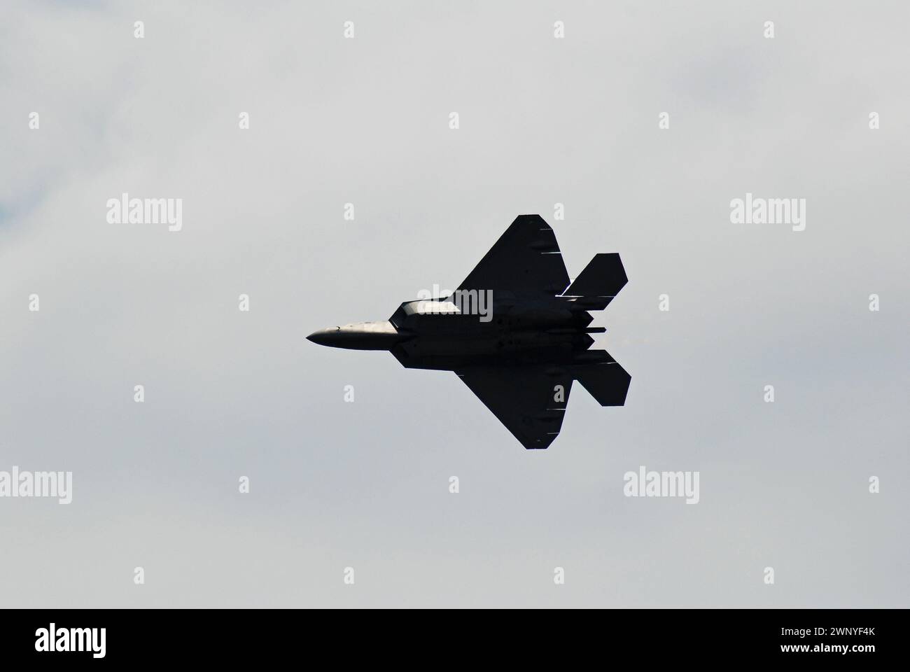 An F-22 Raptor streaks across the sky Stock Photo