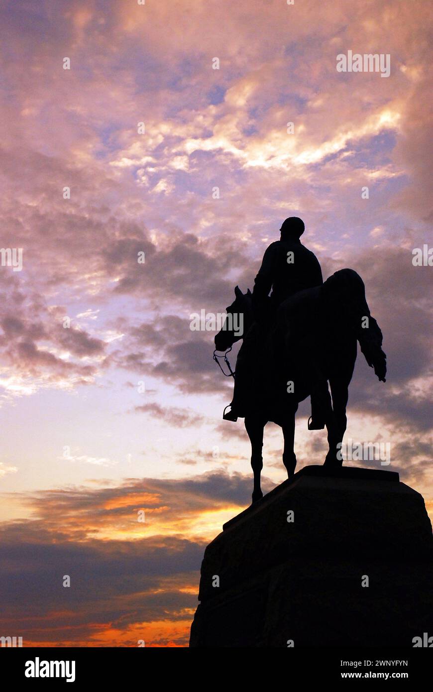 The General Meade Memorial is silhouetted against a sunset sky in Gettysburg National Military Park Stock Photo