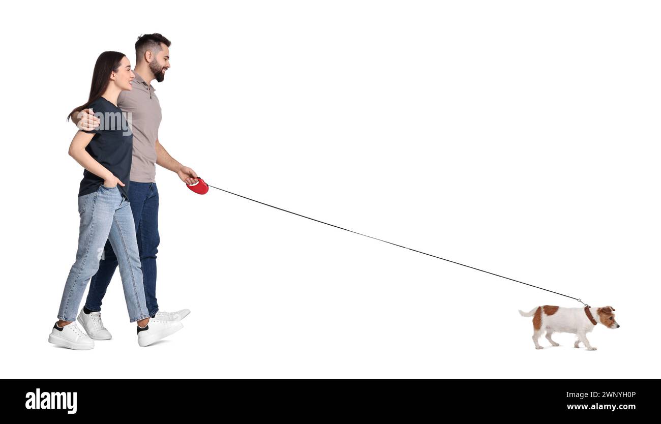 Happy couple walking with dog on white background Stock Photo - Alamy