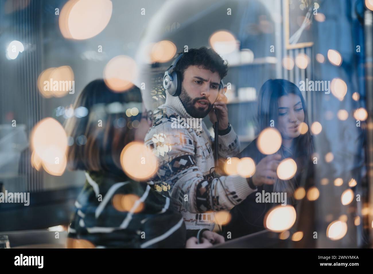 Focused young creative people engaged in collaborative work late at night. Stock Photo