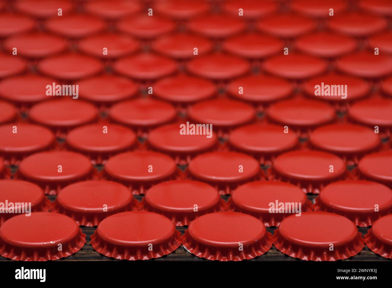 Red beer caps aligned in staggered pattern Stock Photo - Alamy