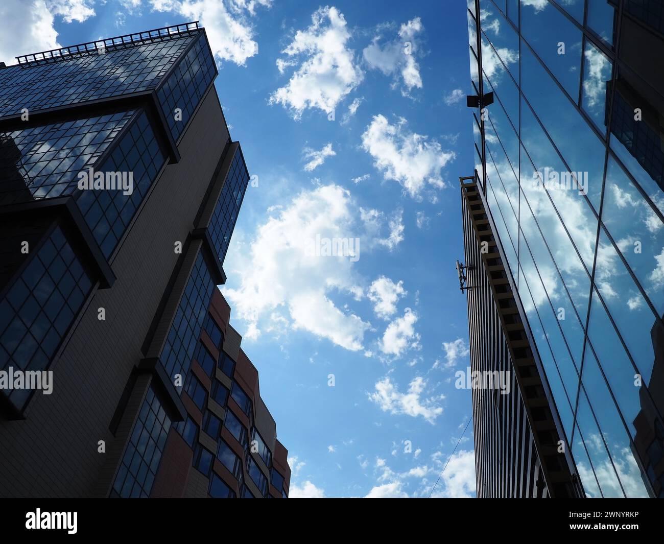 The sky and glass facade of the building. Reflection of the blue sky ...