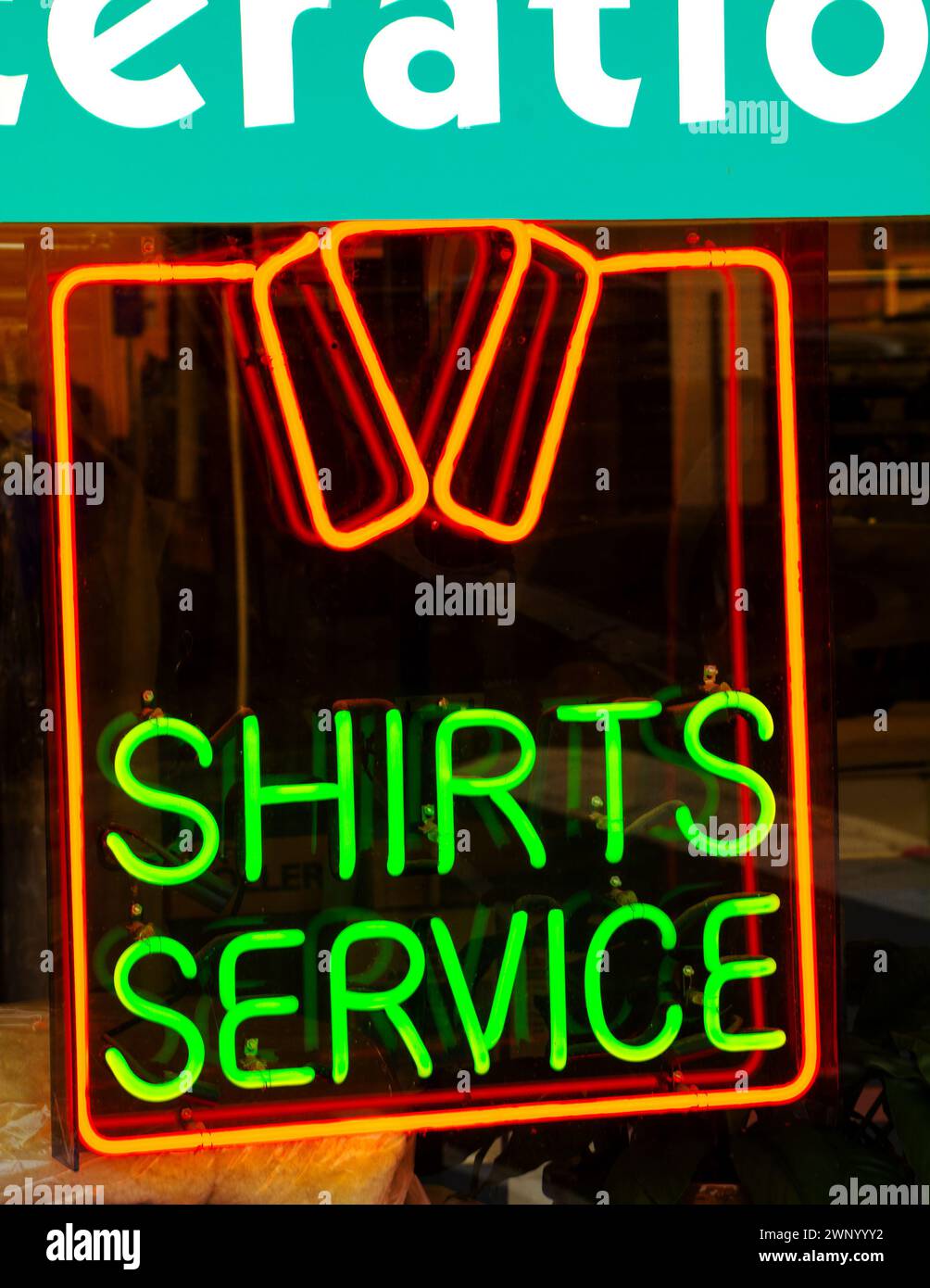 Dry cleaning business advertises with neon signs in window display.Portland, Oregon Stock Photo