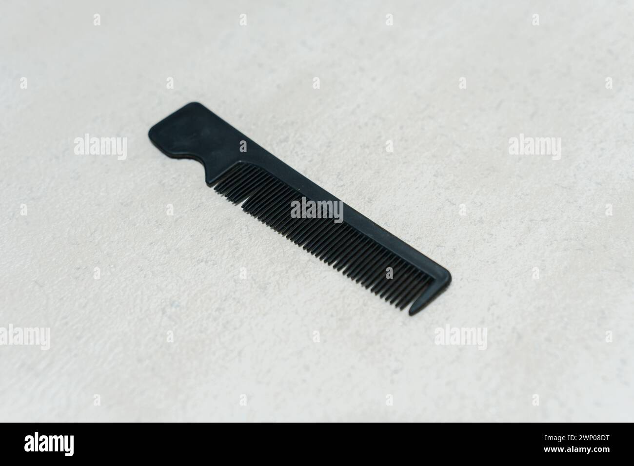 Simple small black plastic comb isolated on white background. Stock Photo