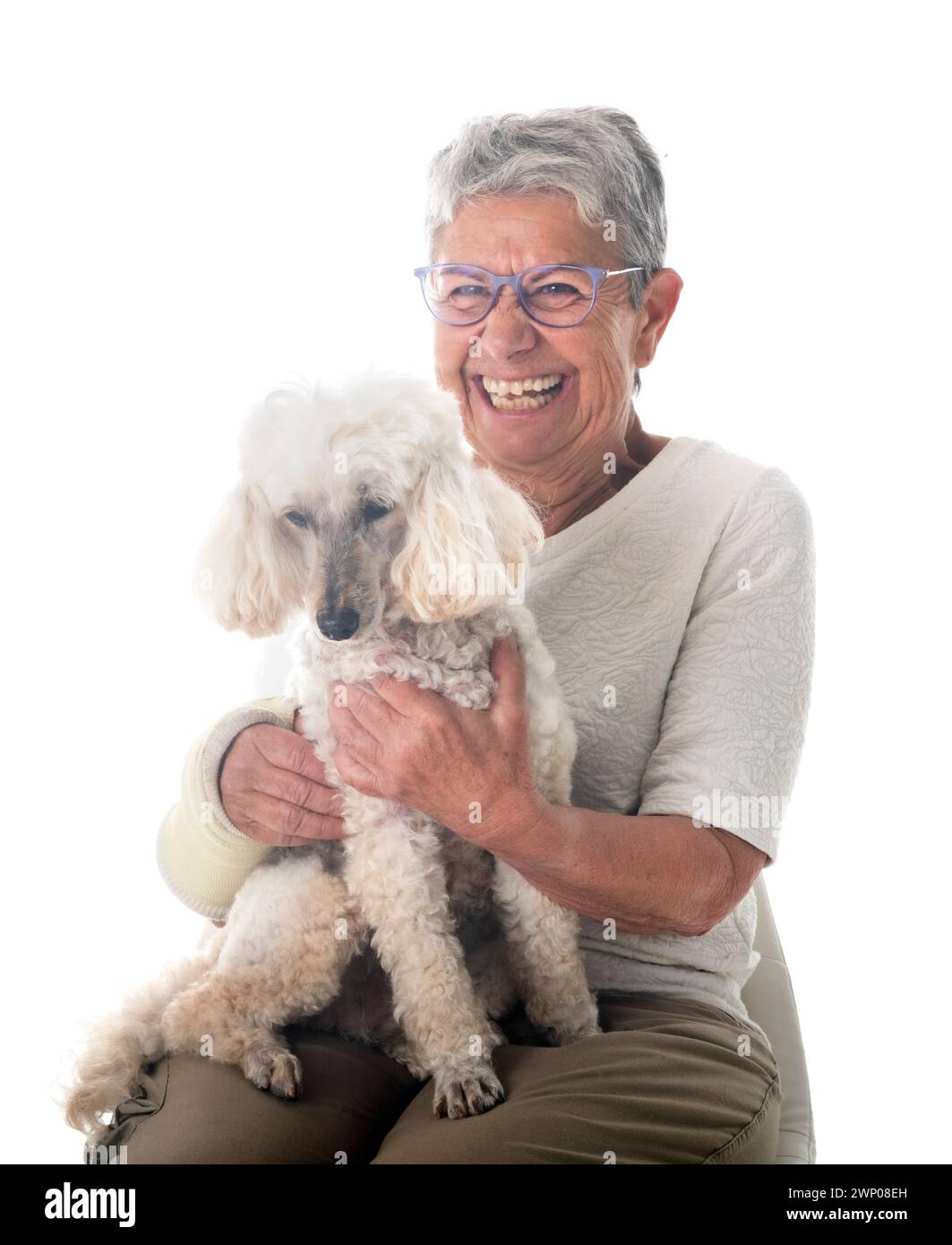 senior woman and dog in front of white background Stock Photo