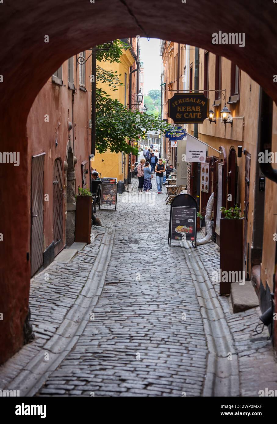 Stockholm, Sweden - July 25, 2023: Charming narrow cobbled street in Gamla Stan historic district of Stockholm, Sweden. Stock Photo