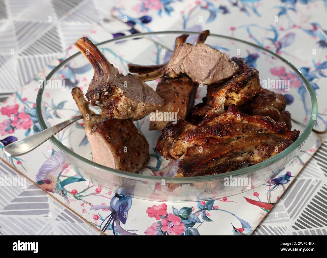 Baked, ready-to-eat saddle of lamb in a glass dish Stock Photo