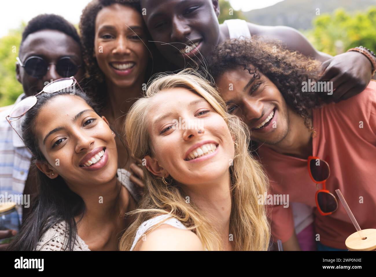 Diverse group of friends smiling for a selfie, showcasing joy and camaraderie Stock Photo
