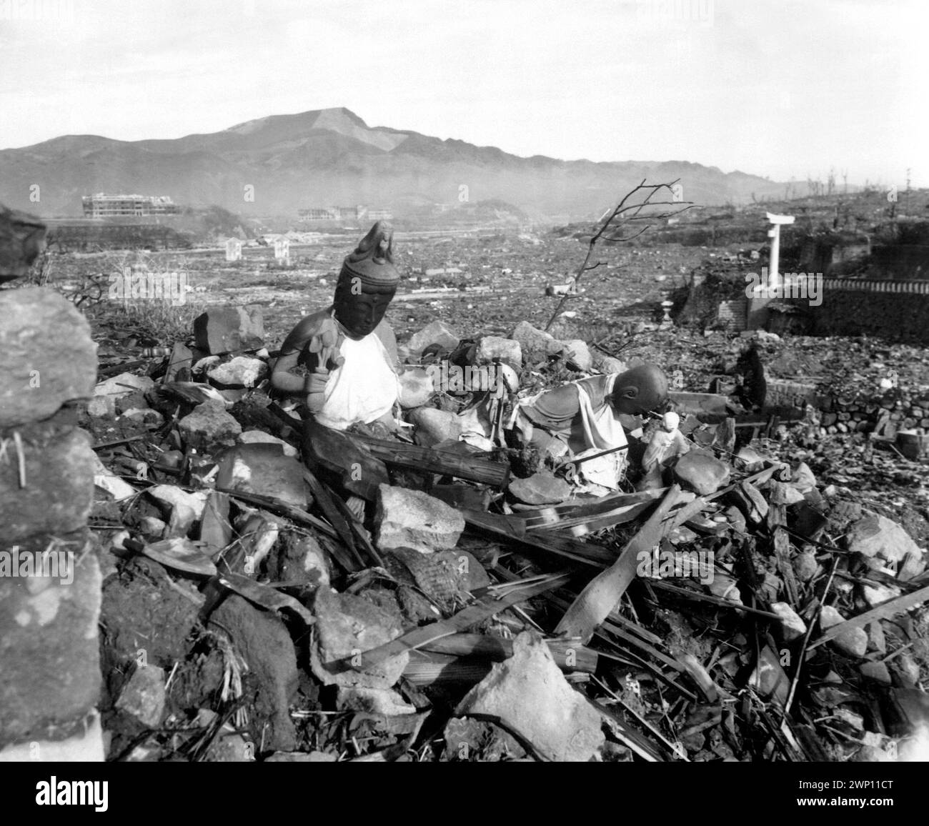 Battered religious figures stand watch on a hill above a tattered valley.  Nagasaki, Japan.  September 24, 1945.  photo by Cpl. Lynn P. Walker, Jr.  (Marine Corps) Stock Photo