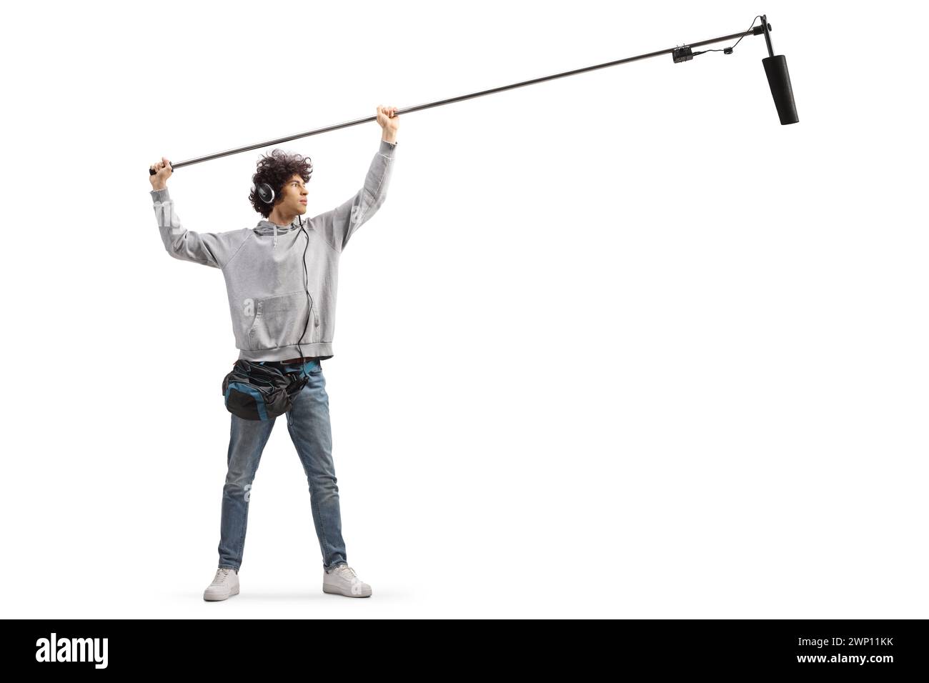Full length shot of audio operator holding a microphone on set  isolated on white background Stock Photo