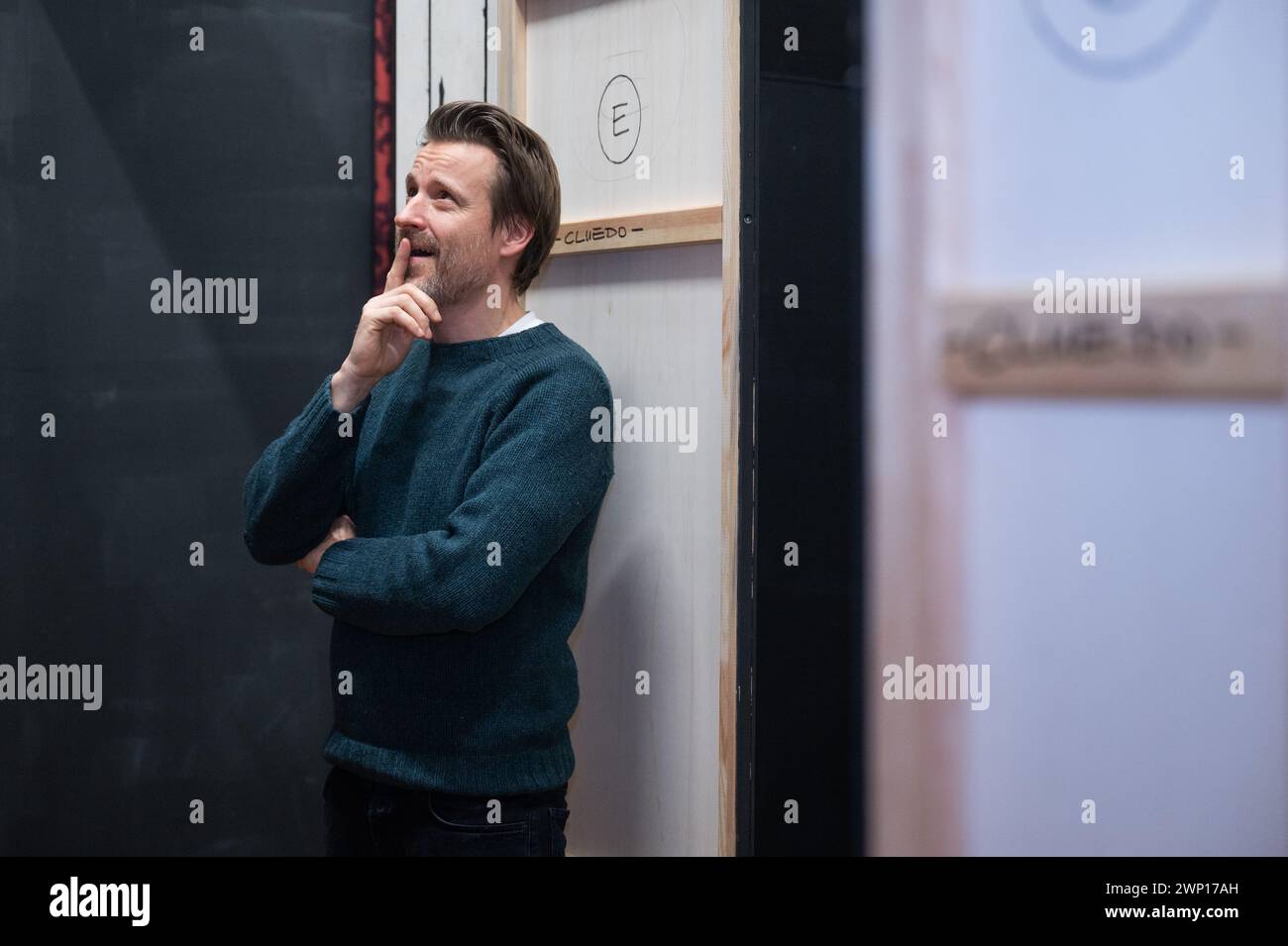 Berlin, Germany. 04th Mar, 2024. Max von Pufendorf, actor, stands behind a theater backdrop from the play 'Cluedo' on the rehearsal stage of the Komödie am Kurfürstendamm at the Theater am Potsdamer Platz. Credit: Christophe Gateau/dpa/Alamy Live News Stock Photo