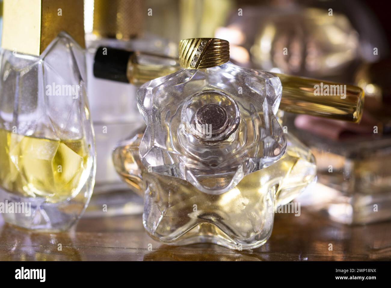 old family ring with diamonds placed on a perfume bottle Stock Photo