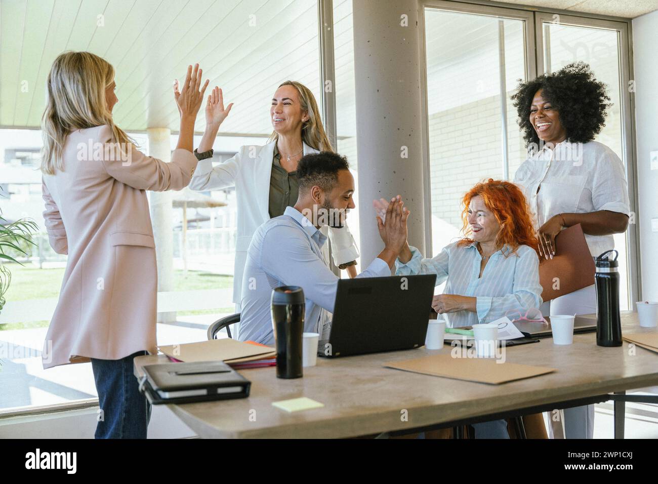 Business colleagues high-fiving while celebrating success. Business concept. Stock Photo