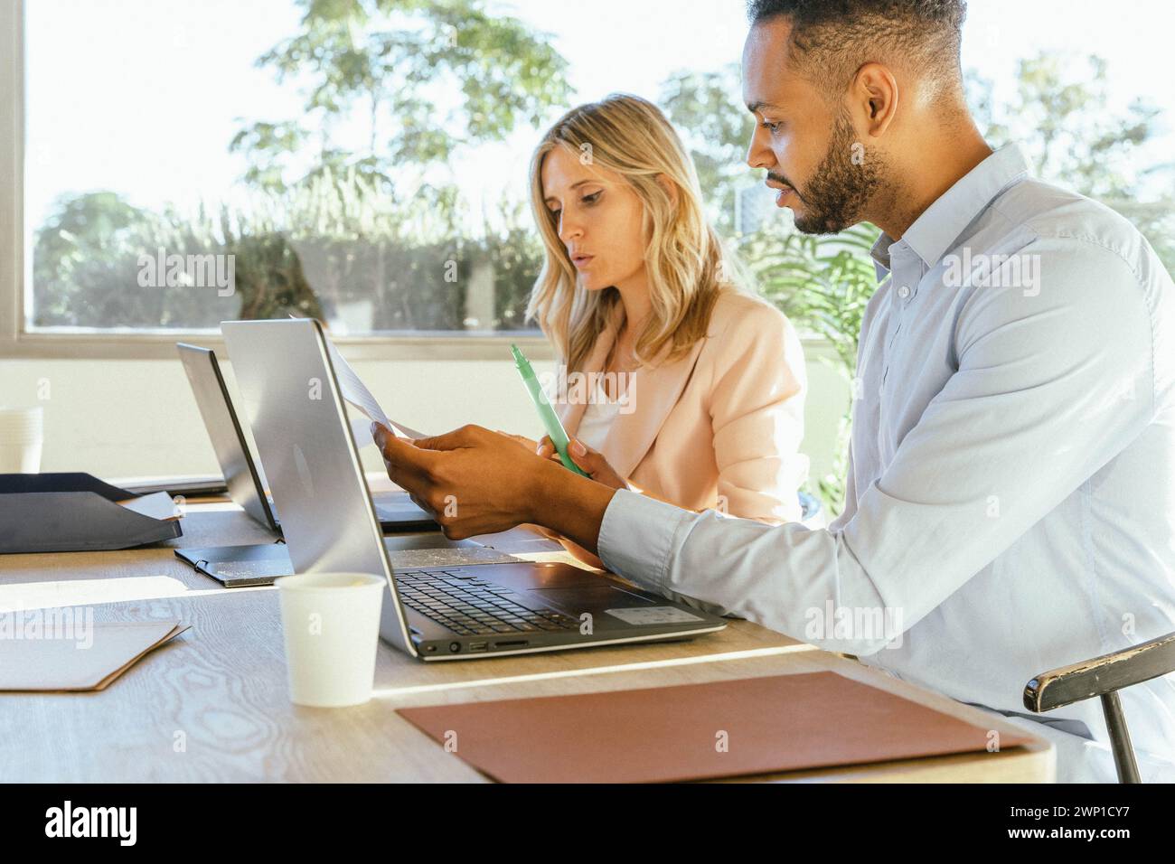 Business colleagues analyzing paperwork while working together in the office. Business concept. Stock Photo