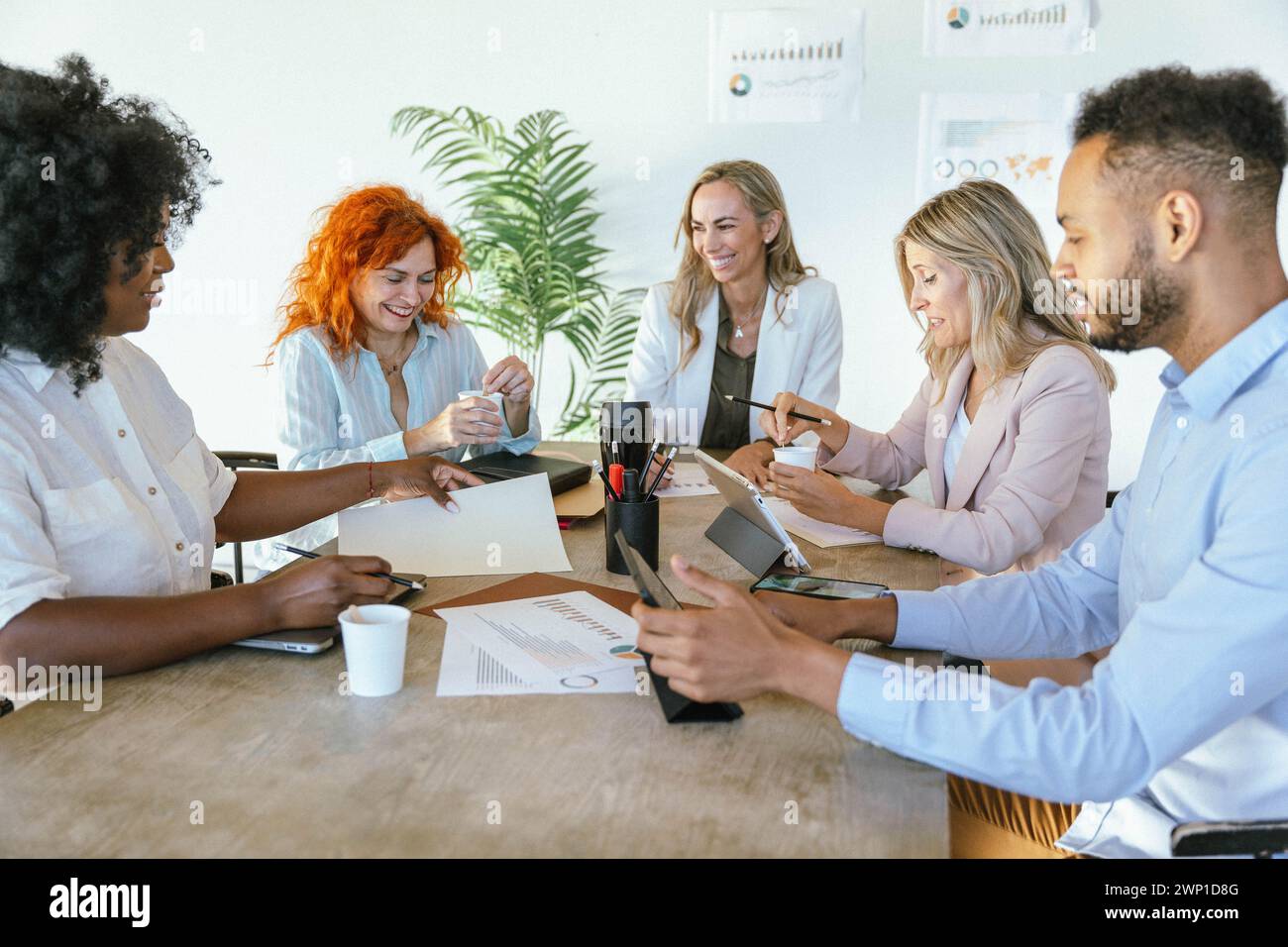 Diverse business people smiling while having a meeting for planning and strategy discussion. Business and brainstorming concept. Stock Photo