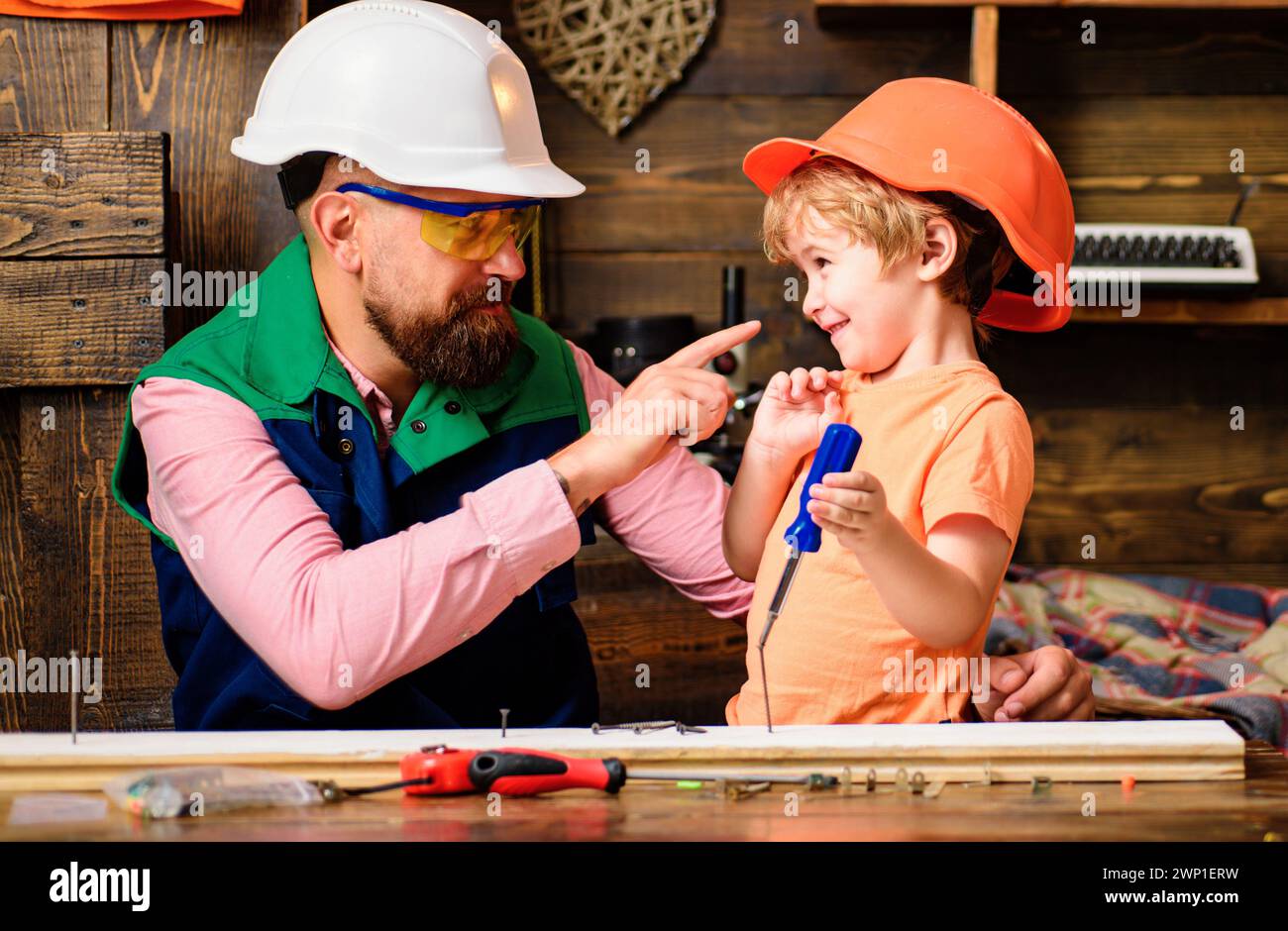 Tools construction. Father teaching little son to use carpenter tools