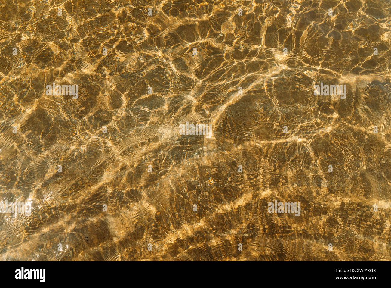 beige sand contrasts with the ocean, making it a work of art in nature. concept for perfumes, smells, heat, freshness, coolness and other associations Stock Photo
