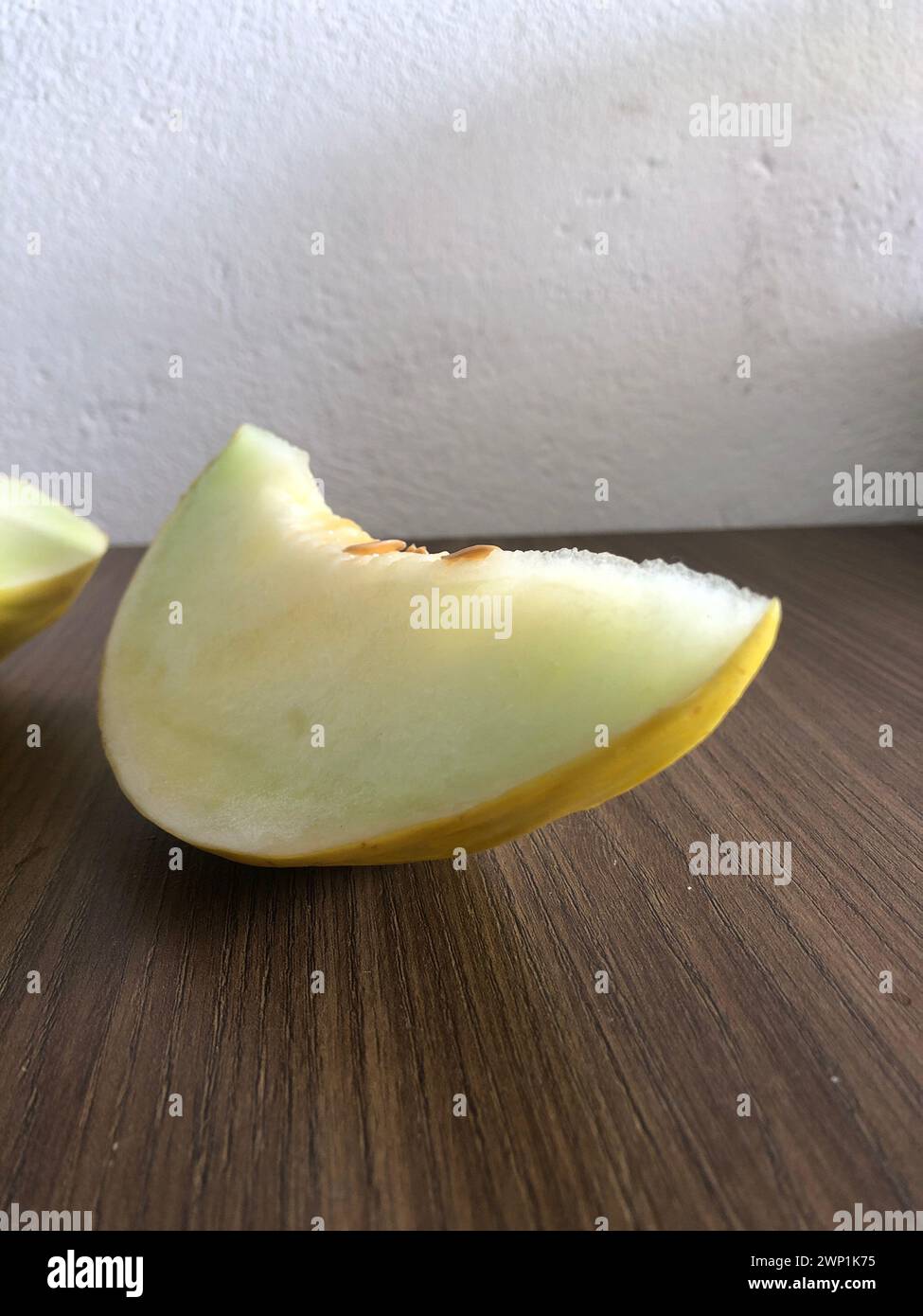 Ripe and fresh melon cut on wooden background with copy space. Cantaloupe or cantaloupe (Cucumis melo) on wooden table background. Favorite fruit Stock Photo