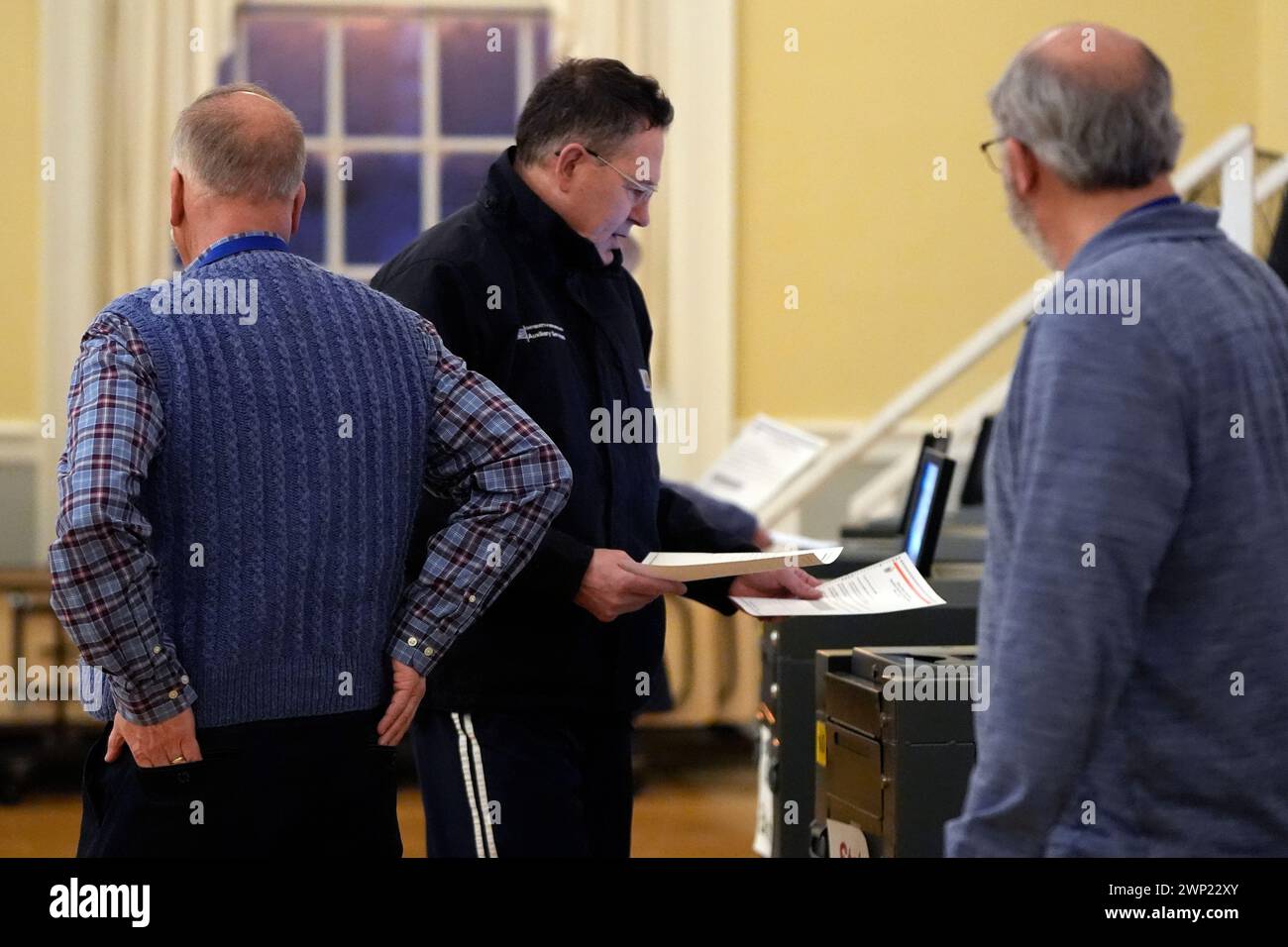 A voter deposits his ballot at the polling station in Kennebunk, Maine