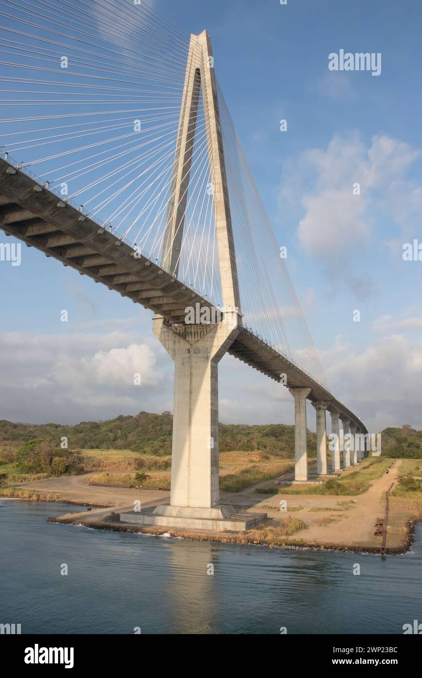 Atlantic Suspension bridge Colon Panama at entrance to the Panama Canal shows height over now shallow water as it routes into the forest Stock Photo