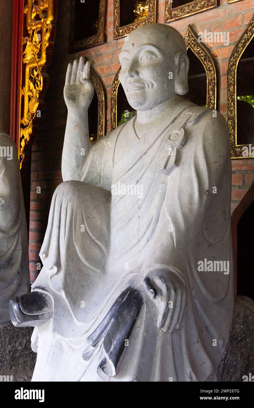 Closeup of one of many stone, Buddhist statues in the Bai Dinh temple pagoda complex in Ninh Binh, northern Vietnam. Stock Photo
