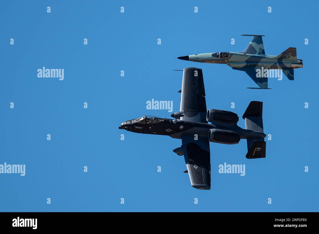 An A-10C Thunderbolt II aircraft flies alongside an F-5 Tiger aircraft during the Heritage Flight Training Course at Davis-Monthan Air Force Base Stock Photo