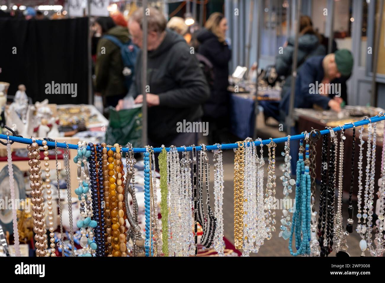 Stalls, sellers and customers perusing the jewellery for sale at Jubilee Market in Jubilee Hall, Covent Garden on 4th March 2024 in London, United Kingdom. Jubilee Market is a covered area in Covent Garden Piazza which is a big draw for tourism in the West End. On Mondays the market specialises in antiques and collectables. Stock Photo