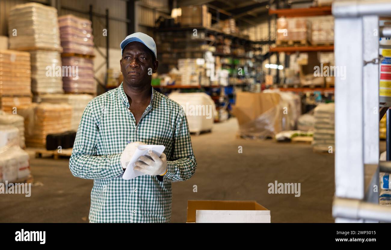 Portrait of focused African-American man checking order list Stock Photo