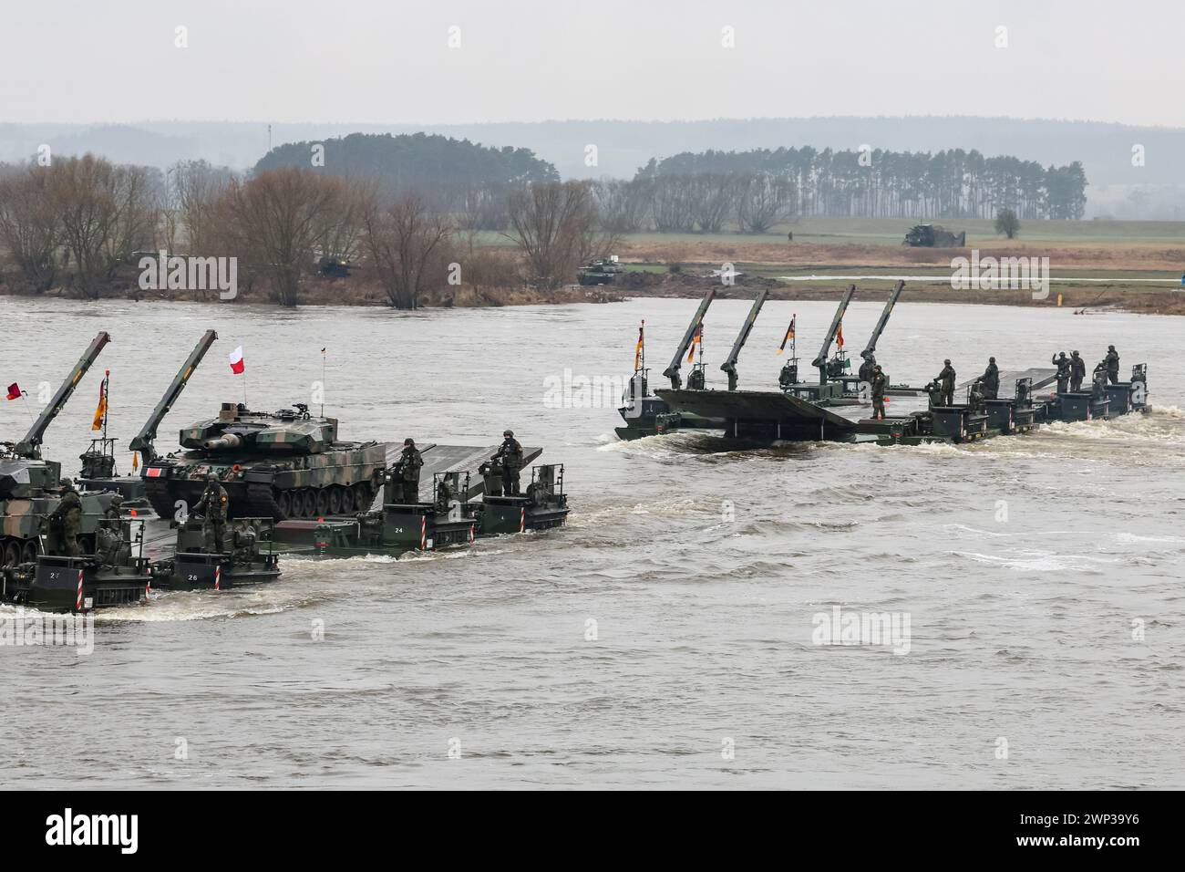 Korzeniewo, Pomorskie, Poland on March 5, 2024. Polish and German servicemen present transfer of tanks and armored vehicles via Vistula river during NATO's Dragon-24 exercise, a part of large scale Steadfast Defender-24 exercise. The exercises, which take place mainly in Central Europe, involve some 90,000 troops from all NATO countries as well as Sweden. The aim of Steadfast Defender-24 is to deter and present defensive abilities in the face of aggression. Credit: Dominika Zarzycka/Alamy Live News Stock Photo