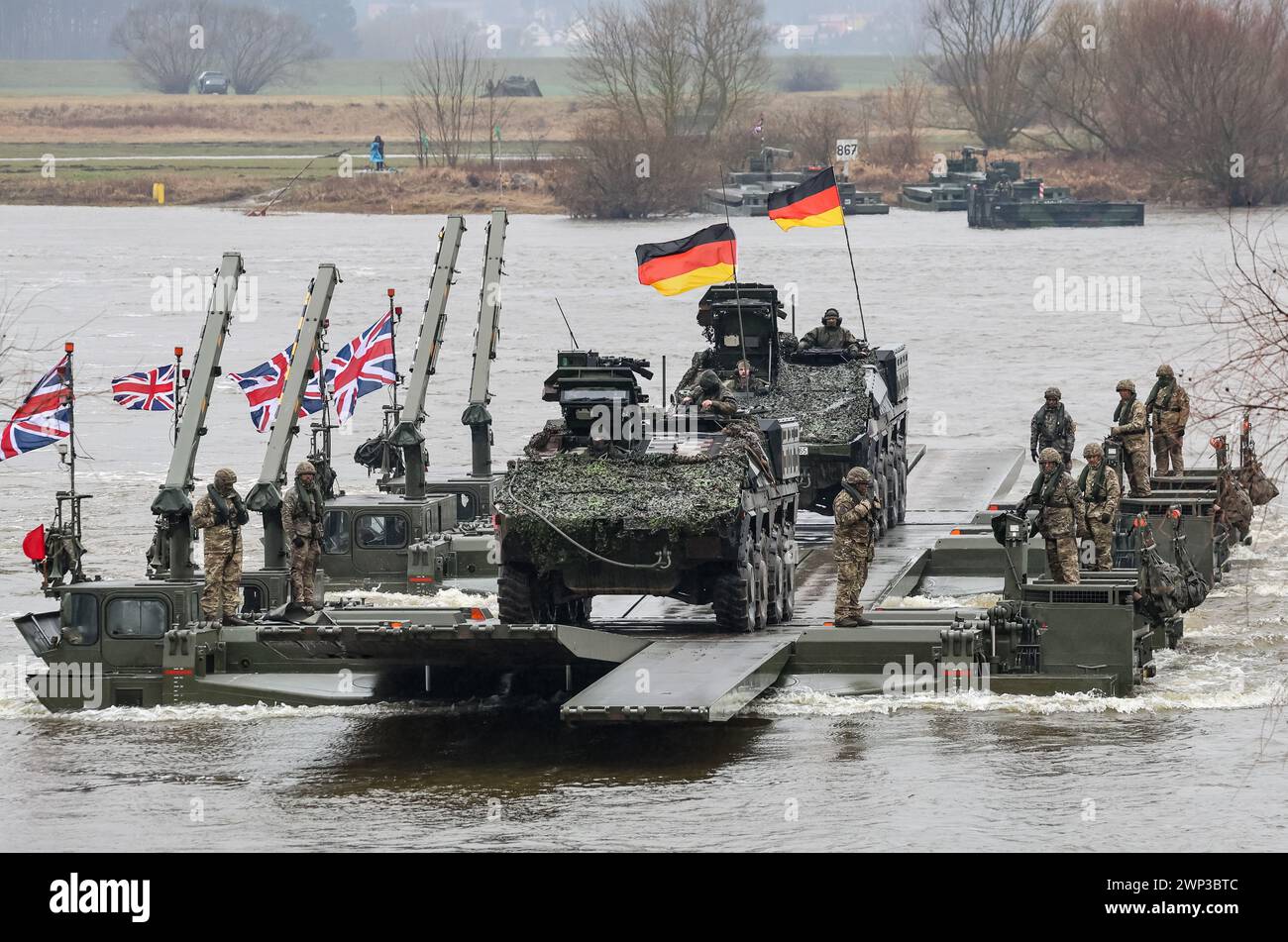 Korzeniewo, Pomorskie, Poland on March 5, 2024. German and British servicemen present transfer of tanks and armored vehicles via Vistula river during NATO's Dragon-24 exercise, a part of large scale Steadfast Defender-24 exercise. The exercises, which take place mainly in Central Europe, involve some 90,000 troops from all NATO countries as well as Sweden. The aim of Steadfast Defender-24 is to deter and present defensive abilities in the face of aggression. Credit: Dominika Zarzycka/Alamy Live News Stock Photo