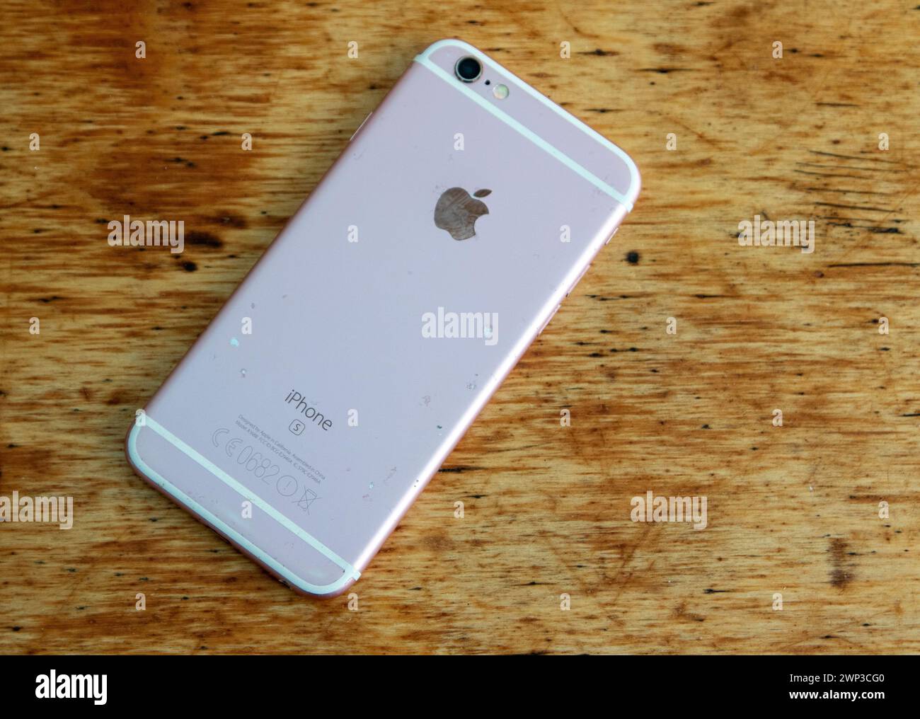 A well used iPhone 6s smartphone launched in 2015 and the first to offer a rose gold colour option Stock Photo