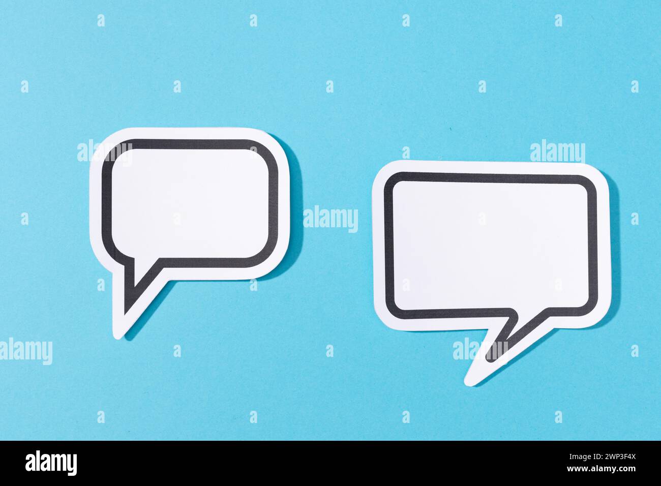 Two Blank Speech Bubble isolated on blue background. Mock up template Stock Photo