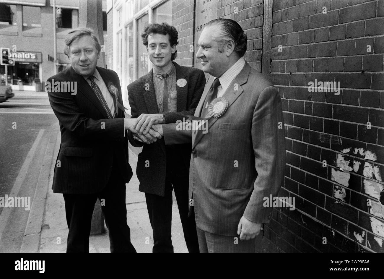 London, England February 1983. Peter Tatchell the Gay Rights campaigner seeks to be elected at the Bermondsey by election South London to the Labour Party as a MP.  Roy Hattersley MP, (L) Peter Tatchell (C) and Bob Mellish MP, (R) who is retiring as the Labour party MP electioneering in Bermondsey. 1980s HOMER SYKES Stock Photo