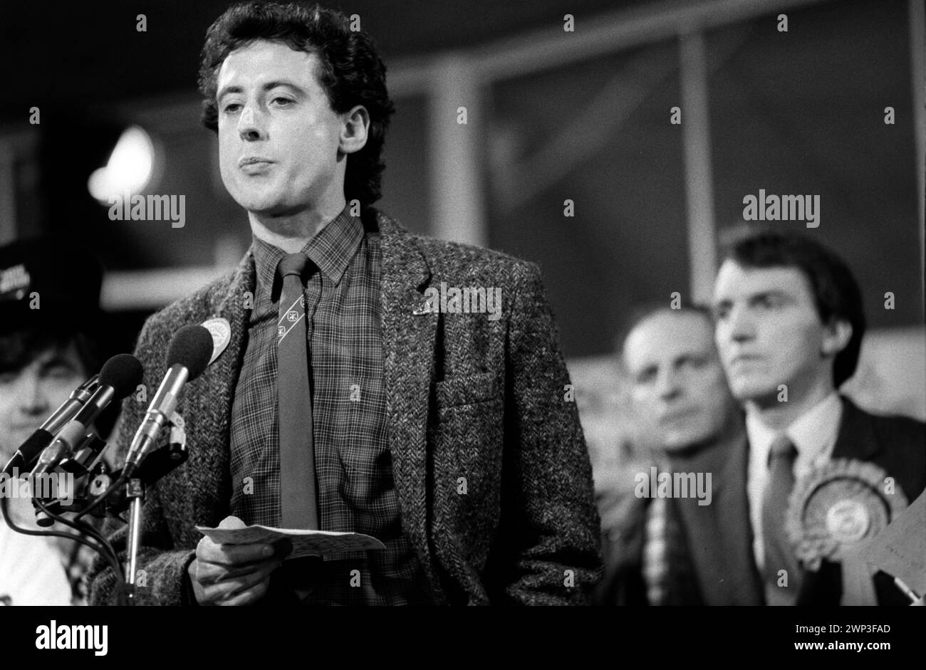 London, England 24th February 1983.  Peter Tatchell the Gay Rights campaigner seeks to be elected at the Bermondsey by election South London to the Labour party as a MP.  Election night debate with Simon Hughes MP. (background) 1980s HOMER SYKES Stock Photo