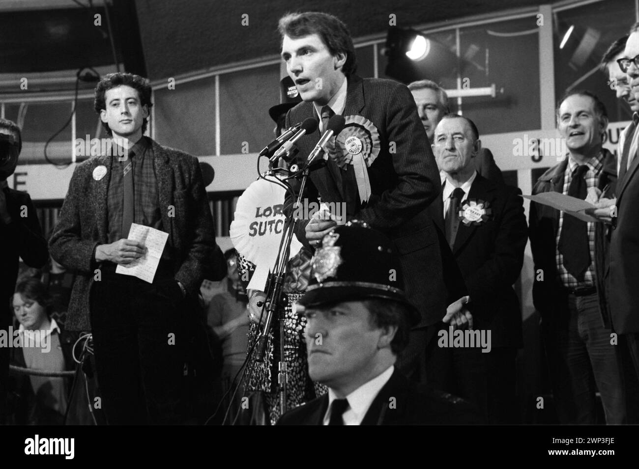 London, England 24th February 1983. Peter Tatchell the Gay Rights campaigner seeks to be elected at the Bermondsey by election South London to the Labour party as a MP. Election night, Tatchell lost to Simon Hughes (Liberal party centre) who is making his acceptance speech. 1980s HOMER SYKES Stock Photo