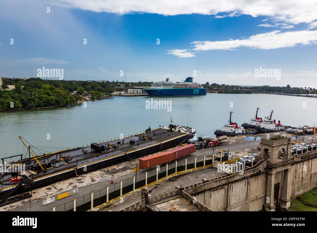 View of the Harbor of Santo Domingo from the Ozama Fortress, Dominican Republic.  In the foreground are three tugboats and the  Asphalt Contender barg Stock Photo