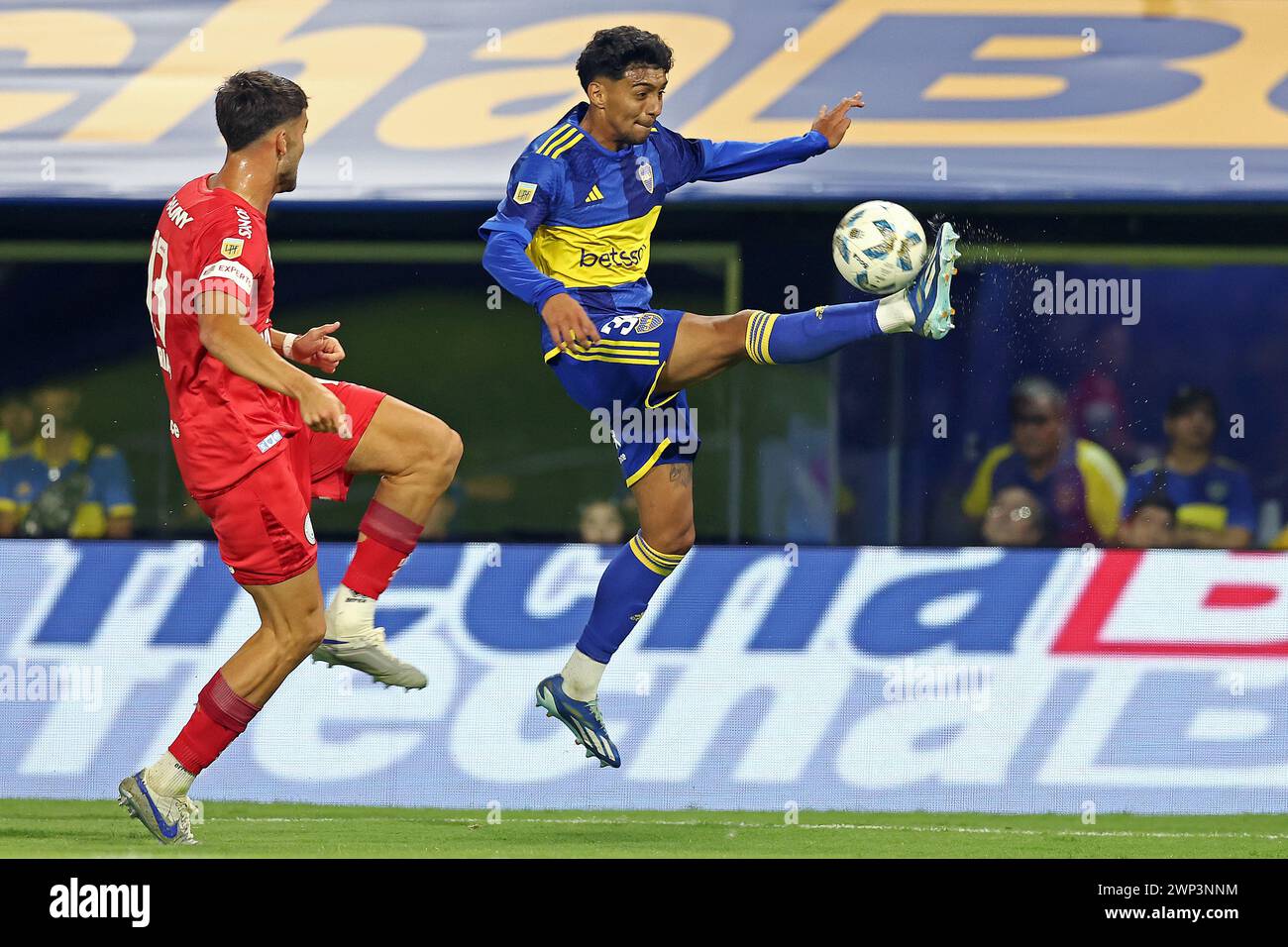 Boca Juniors’ midfielder Cristian Medina (R) controls the ball next Belgrano's defender Nicolas Meriano during the Argentine Professional Football League Cup 2024 match at La Bombonera stadium in Buenos Aires on March 3, 2024.  Boca Juniors won by 3-2 and Cavani scored a hat-trick.  (Photo by Alejandro Pagni / PHOTOxPHOTO) Stock Photo
