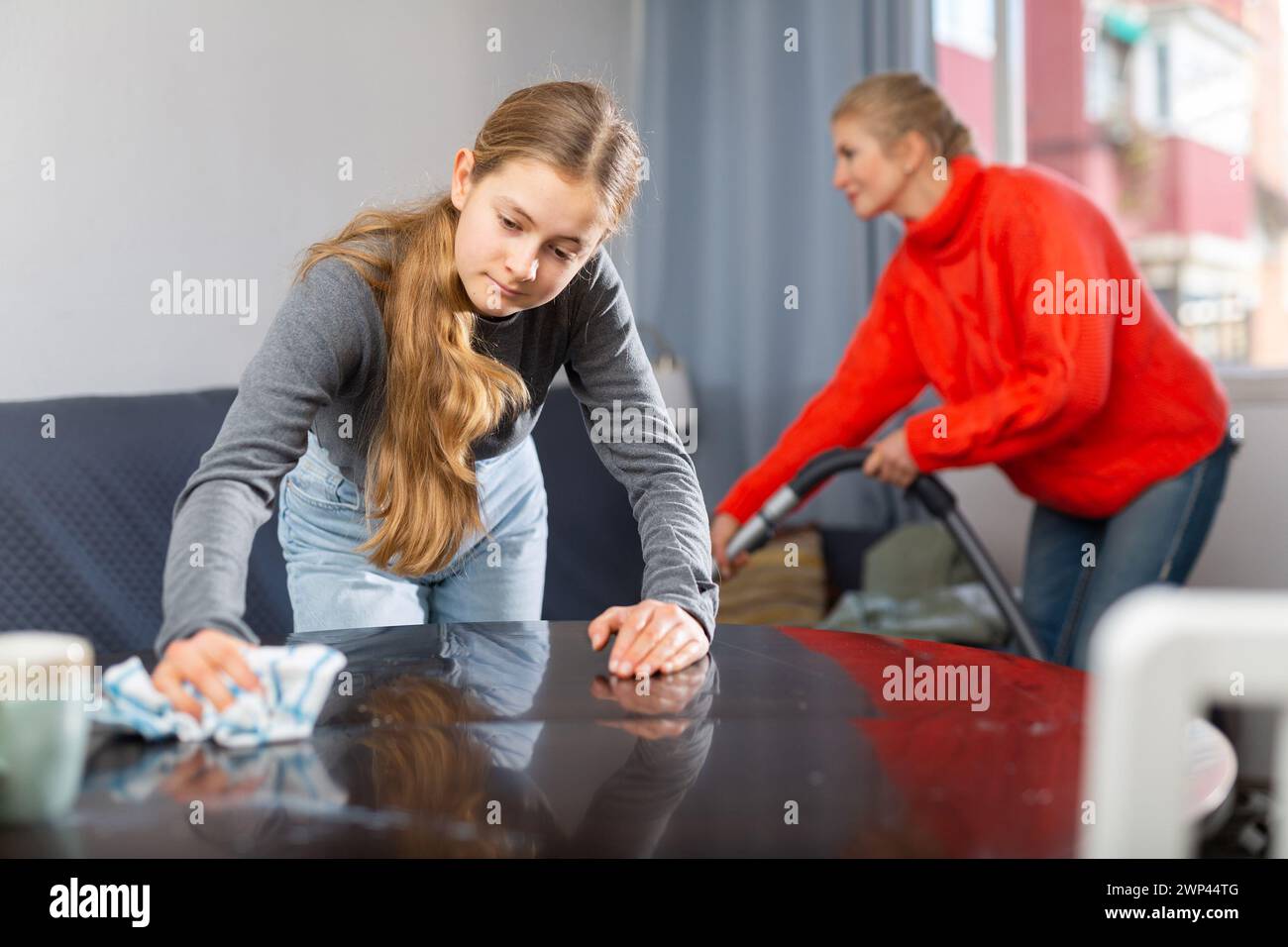 Daughter dusting table mother hi-res stock photography and images - Alamy